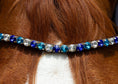 Load image into Gallery viewer, Brauner Stirnriemen Majestic (Nr. 109.) mit großen 109.4 blauen Glitzersteinen von der Marke Ascot Reitsportartikel.